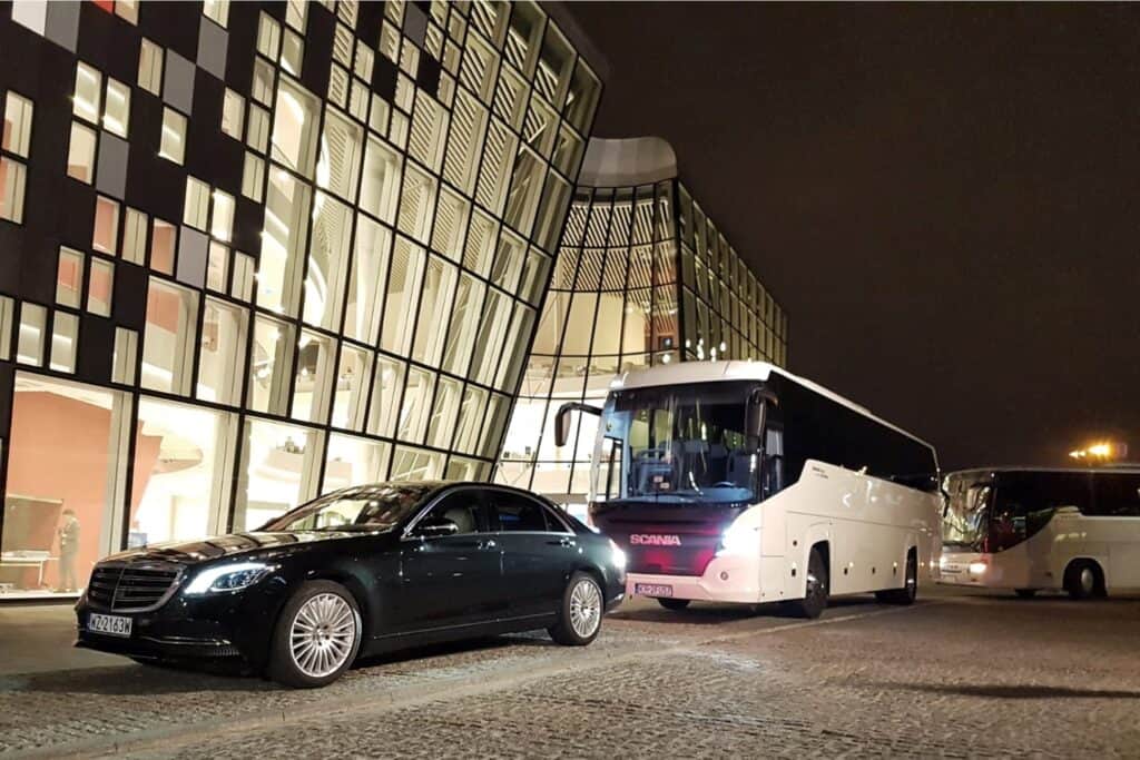 Samochody Mercedes-Benz S-class limousine with 50-seater coach in front of the International Congress Centre in Krakow