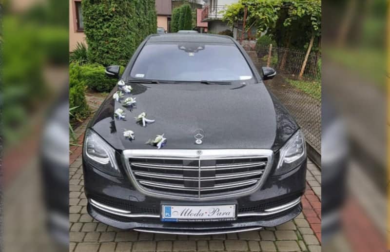 Decorated Mercedes-Benz S-class limousine with a Just married license plate ready for car rental